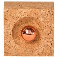 an image of a round hole in the cork wall with light coming from it's center