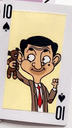 an image of a man holding a teddy bear in front of his face and playing cards