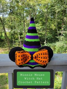 a crocheted hat with an orange bow tie and a green sign that says, minnie mouse witch hat crochet pattern