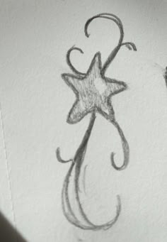 an ink drawing of a star and swirls on the side of a piece of paper