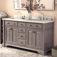 a bathroom with double sinks and mirrors on the wall