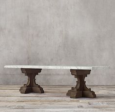 two stone pedestals are shown in front of a concrete wall and wood flooring