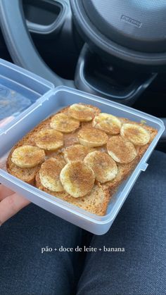 a person holding a plastic container with food in it