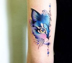 a watercolor cat tattoo on the arm