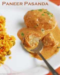 a white plate topped with rice and meat covered in sauce