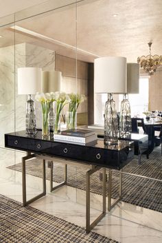 a table with vases and flowers on it in front of a mirror that reads contemporary decor makeover