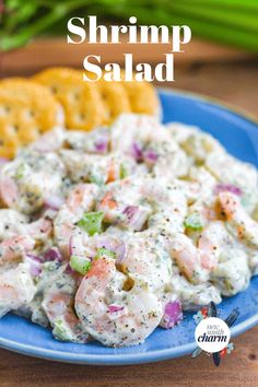 a blue plate topped with salad next to crackers