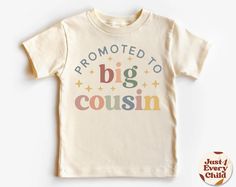 a t - shirt with the words, promote to big cousin on it