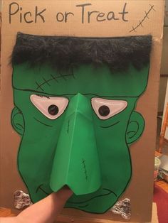 a cardboard cut out of the face of a green monster