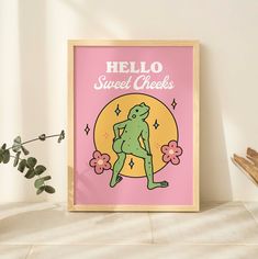 a pink poster with the words hello sweet cheeks on it next to a potted plant