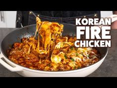 korean fire chicken is being cooked in a skillet