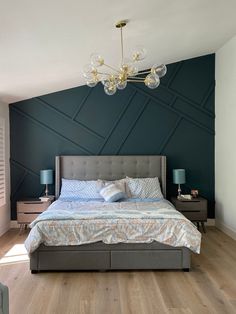 a bedroom with a bed, nightstands and a chandelier hanging from the ceiling