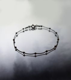 Black Moon. Composed of oxidized silver chain and shinny black spheres. Perfect piece for layering with other blacelets! Ideal for a dark yet minimalist aesthetic. Not sure which length to buy? We can add a 1 inch extender chain. Just write a note at checkout! ❈ We send all our items with registered mail. ❉ Due to the organic nature of stones, there might be a slight variation in colour, size and shape. ✺ All items come packaged in a quality velvet pouch ready for gift giving. ✽ If you want to m Adjustable Minimalist Ball Chain Bracelet, Minimalist Sterling Silver Satellite Chain Bracelet, Minimalist Black Chain Bracelet, Silver Minimalist Satellite Chain Bracelet, Minimalist Silver Satellite Chain Bracelet, Minimalist Oxidized Finish Bracelets As Gift, Minimalist Oxidized Finish Bracelets For Gift, Minimalist Bracelets With Oxidized Finish As Gift, Black Oxidized Chain Bracelet As Gift