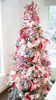 a christmas tree decorated with bows and ornaments