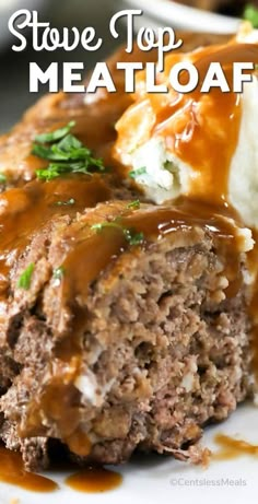 some meatloaf with gravy and mashed potatoes on a white plate