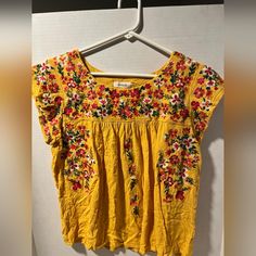 Brighten Up Your Day With This Sunshiny Faveur Blouse! This Medium-Sized Top Showcases Cap Sleeves And Is Adorned With A Stunning Floral Embroidery, Making It A True Standout Piece. Crafted From Soft, 100% Rayon Fabric, It Promises Comfort Along With Style. - **Size:** Medium - **Color:** Mustard Yellow With Multicolor Embroidery - **Material:** 100% Rayon - **Condition:** New Without Tags, Flawless Condition Perfect For Spring And Summer Days, Or Brightening Up Any Casual Look. Hand Wash Only - Multicolor Embroidery, Cap Sleeve Blouse, Posh Style, Cap Sleeves Blouse, Embroidered Cap, Embroidery Materials, Embroidered Caps, Eco Friendly Fashion, Rayon Fabric