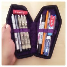 an open case with pens and markers in it