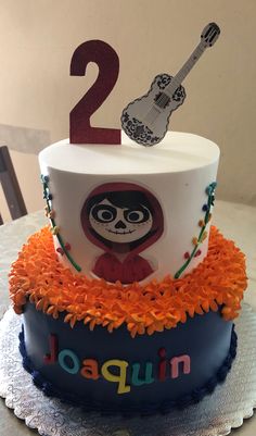 a birthday cake with an image of a skeleton on top and the number two in spanish