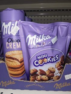 three bags of cookies sitting on top of a shelf