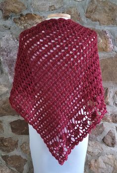 a knitted shawl on top of a mannequin head