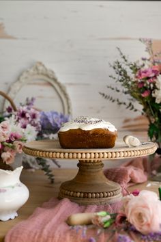 a cake sitting on top of a wooden stand