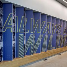 the wall is decorated with blue and yellow letters that spell out all ways in front of them