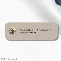 the name plate for alexandria miller receptionists is shown in gold and black on a white background