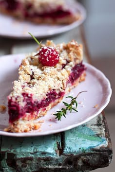 a piece of pie with cranberry topping on a plate next to another slice