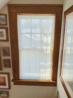 a bathroom with a window and pictures on the wall