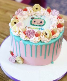 there is a cake that has been decorated with buttons and flowers on it, sitting on a plate