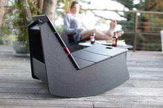 a man sitting at a table with two beer bottles and a laptop on it,