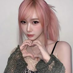 a young woman with pink hair is posing for the camera