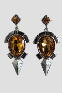 Topaz, a gem that harnesses the power of lightning to increase electrical resistance. With electric enemies on the prowl, you'll need jewelry head gear armor with Shock Resistance! These real life earrings were inspired by the Topaz Earrings worn by Link in the Legend of Zelda Breath of the Wild. The earrings are silver colored and shaped and detailed like in game, complete with a topaz gem center and topaz gem piece on top. Every little detail was carefully replicated as it appears in the Starl Legend Of Zelda Earrings, Gem Top, Zelda Breath Of The Wild, Head Gear, Casual Cosplay, Legend Of Zelda Breath, Zelda Breath, Topaz Earrings, Breath Of The Wild