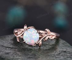 a white opal ring with leaves on it