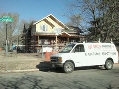 a white van parked in front of a house under construction