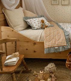 a wooden bed sitting in a bedroom on top of a floor next to a chair