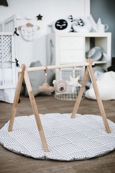 a baby's room with a swing set and toys on the floor in front of it