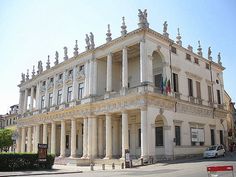 an old building with columns and pillars on the front