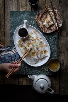 a plate with some food on it and chopsticks