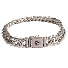 Impressive links of sterling silver are formed together into a length of glimmering curb link chain that circles the wrist. Balinese artisan Cahya Krisna designs this striking chain bracelet, closing it with a box clasp accented with a flower design.