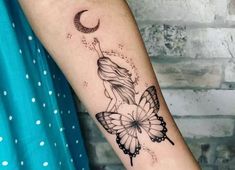 a woman's arm with a butterfly tattoo on it and a crescent moon behind her