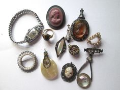 Antique 1800s - 1920s jewelry lot with total of 12 pieces all need a cleaning very old. You will find a gold filled tiger eye ring, gold filled pin, pendants, brooch and a art deco watch. (please see all photos. Antique Formal Jewelry With Cabochon, Victorian Antique Gold Brooch Jewelry, Antique Gold Victorian Brooch Jewelry, Antique Oval Brooch Jewelry, Victorian Vintage Charm Jewelry, Antique Collectible Jewelry Brooch, Vintage Antique Gold Collectible Jewelry, Vintage Antique Gold Jewelry Hallmarked, Vintage Antique Gold Hallmarked Jewelry