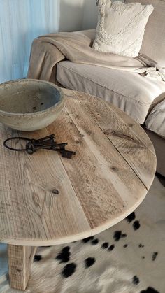 a wooden table sitting in front of a couch