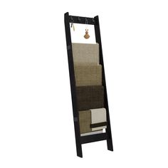 a tall wooden shelf with towels hanging from it's sides