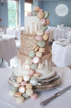 a wedding cake with macaroni and cheese on the top is surrounded by silverware