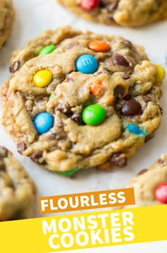 monster cookies with m & m's on top and the words flourless monster cookies