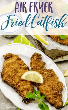 fried fish on a plate with lemon wedges and parsley garnish in the background