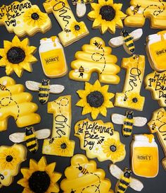 decorated cookies are arranged in the shape of sunflowers, bees and honey jars