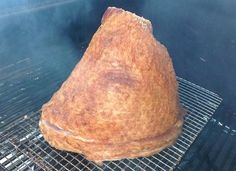 a large piece of food cooking on top of a grill