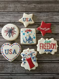 decorated cookies are arranged on a wooden table